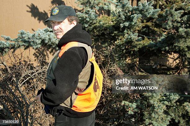 Anchorage, UNITED STATES: Wildlife Biologist for the Alaska Department of Fish and Game Rick Sinnott tracks a moose on a neighborhood trail in...