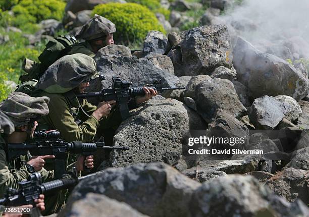 Israeli infantry troops from the elite reconnaissance battalion of the Israeli army's Nahal brigade open fire on enemy positions during a live-fire...