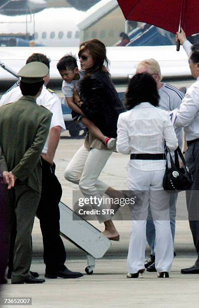 Hollywood movie star Angelina Jolie carries her newly adopted Vietnamese three-year-old son Pax Thien Jolie as she boards a jet at Hanoi's Noibai...