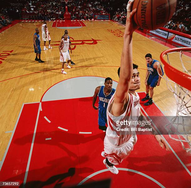 Yao Ming of the Houston Rockets takes the ball to the basket during a game against the Orlando Magic at Toyota Center on March 11, 2007 in Houston,...