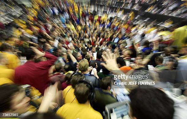 Chicago, UNITED STATES: Traders signal prices in the Euro Dollar pit 21 March, 2007 at the Chicago Mercantile Exchange following the announcement by...