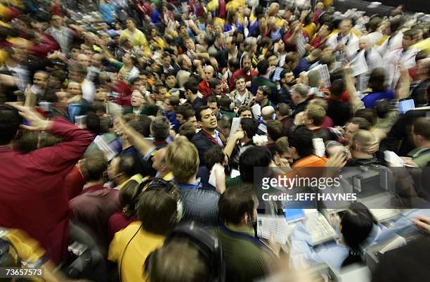 Chicago, UNITED STATES: Traders signal prices in the Euro Dollar pit 21 March, 2007 at the Chicago Mercantile Exchange following the announcement by...