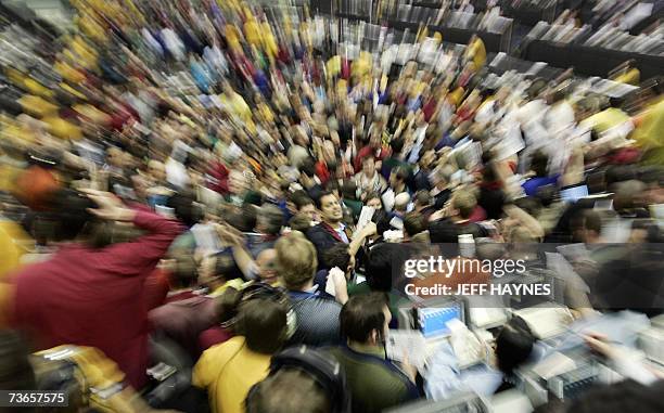 Chicago, UNITED STATES: Traders signal prices in the Euro Dollar pit 21 March, 2007 at the Chicago Mercantile Exchange following the announcement by...