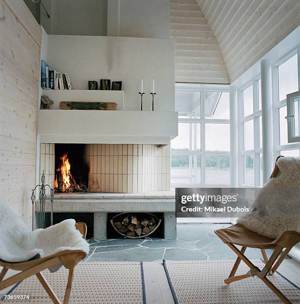 chairs in front of a fireplace. - sheepskin stock pictures, royalty-free photos & images