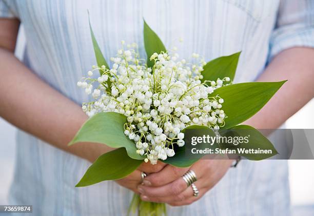 woman with a bouquet of lilies of the valley. - lily of the valley imagens e fotografias de stock