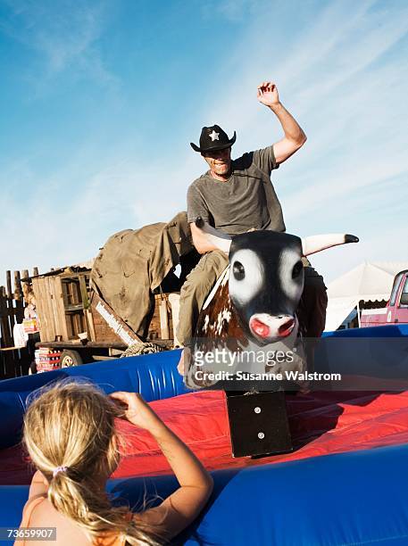 rodeo in a amusement park. - mechanical bull stockfoto's en -beelden