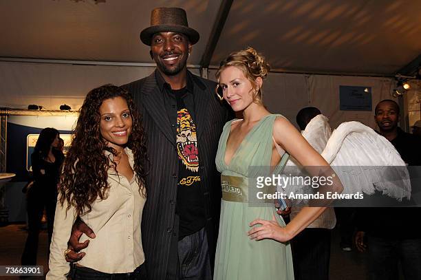 Former NBA player John Salley and wife pose with the Gran Centenario angel during Mercedes Benz Fashion Week held at Smashbox Studios on March 21,...