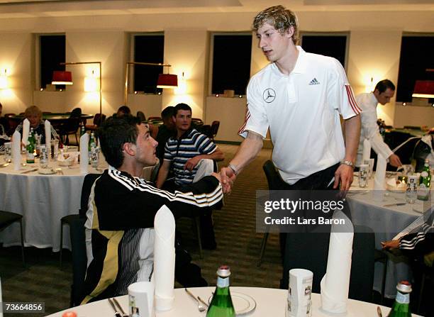 Stefan Kiessling of Bayer Leverkusen shake hands with U 21 player Marcel Heller of Aachen during the joint venture supper of the German National...