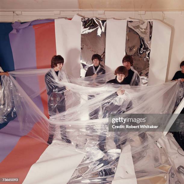 The Beatles experiment with poythene sheeting during a photo shoot in a studio in Hampstead, London, December 1965. Left to right: George Harrison ,...
