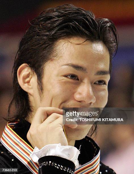 Japanese skater Daisuke Takahashi bites his silver medal on the podium after the men's singles of the World Figure Skating Championships 2007 in...