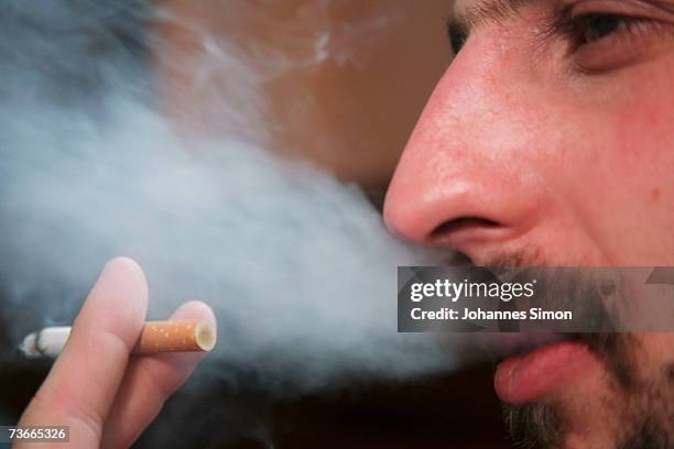 Man smokes in traditional restaurant "Weisses Braeuhaus", March 22, 2007 in Munich, Germany. German lawmakers are currently wrangling over proposed...