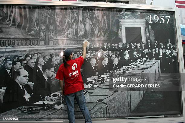 Man cleans a display for the 50th anniversary of Europe at the European Council building in Brussels, 22 March 2007. The picture in the background...