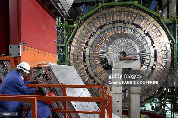 Engineer works to assemble 22 Mars 2007 near Geneva one of the layers of the world's largest superconducting solenoid magnet , one of the experiments...