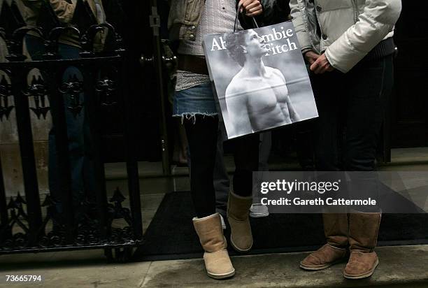 Shoppers leave the Abercrombie & Fitch UK Flagship Store on Savile Row on March 22, 2007 in London, England. The store opened its doors today and is...