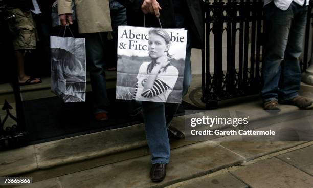 Shoppers leave the Abercrombie & Fitch UK Flagship Store on Savile Row on March 22, 2007 in London, England. The store opened its doors today and is...