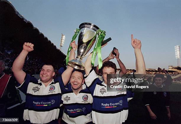 Bath rugby players Mark Regan, Ieuan Evans and Mike Catt celebrating their team's 19 - 18 points victory over Brive in the Heineken Cup final at the...