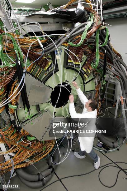 Technician works 22 Mars 2007 near Geneva, at the building of the cap of the world's largest superconducting solenoid magnet , one of the experiments...