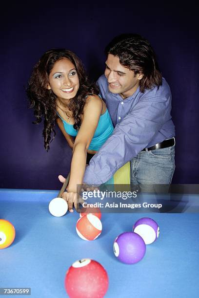 man teaching woman how to play pool - pool table moving stock pictures, royalty-free photos & images