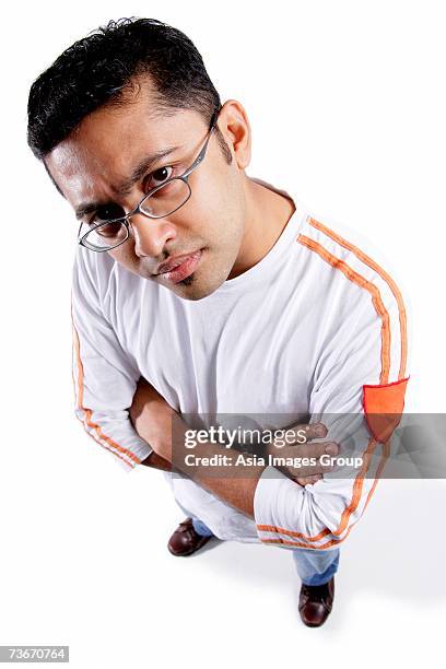 man looking at camera, arms crossed, frowning - pensive indian man stock pictures, royalty-free photos & images
