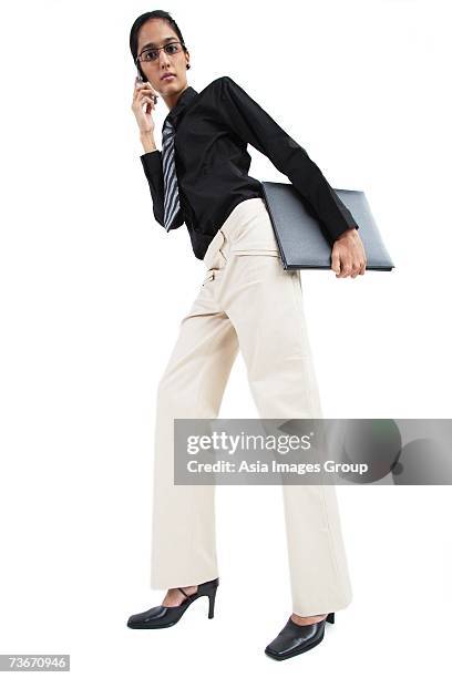 business woman using mobile phone, low angle view - group of businesspeople standing low angle view stock pictures, royalty-free photos & images