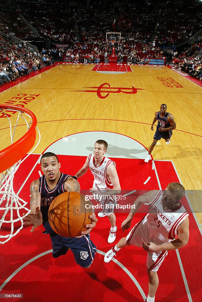 Houston Rockets Marcus Marcus Williams of the New Jersey Nets goes for a layup past Jake ...