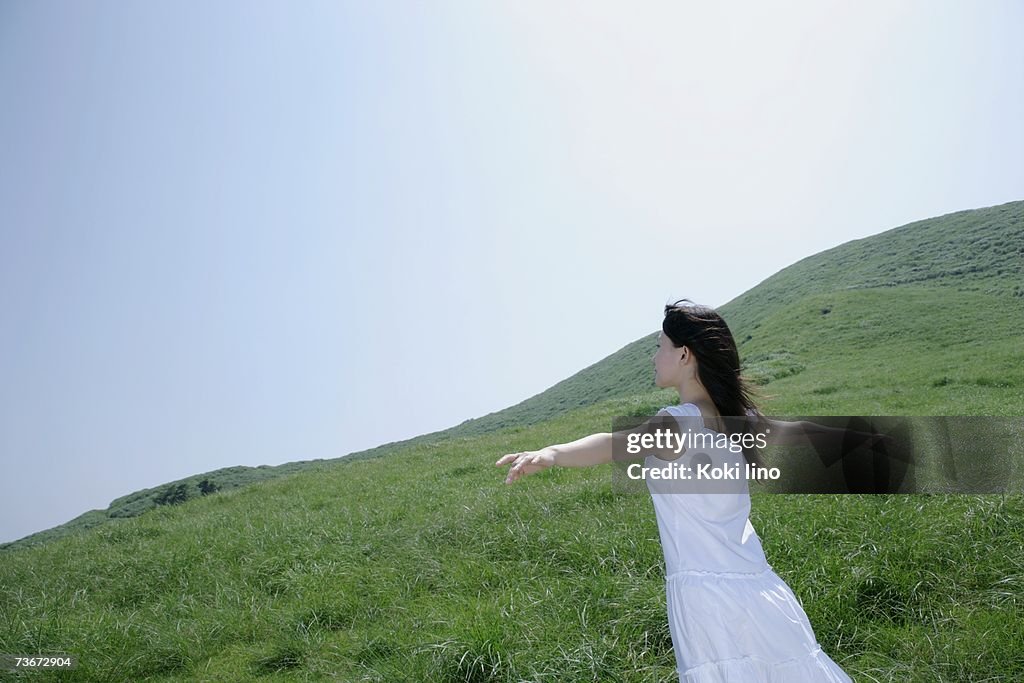 A young woman standing in field