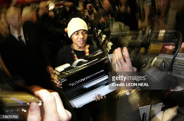 London, UNITED KINGDOM: Ritasu Thomas, aged 17, holds up his Playstation 3 in the Virgin Megastore, London on the day that Sony launches its...