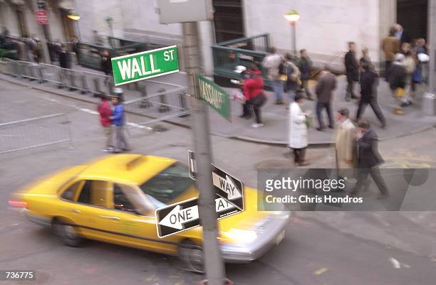 Taxis and people fill the streets on Wall Street November 15, 2000 in the center of New York City's financial district. The corner, in 1972, was a...