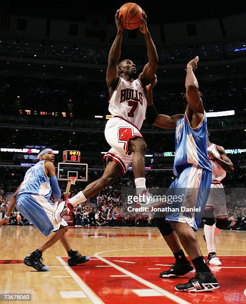 Ben Gordon of the Chicago Bulls drives to the basket between Allen Iverson and Nene of the Denver Nuggets on March 22, 2007 at the United Center in...