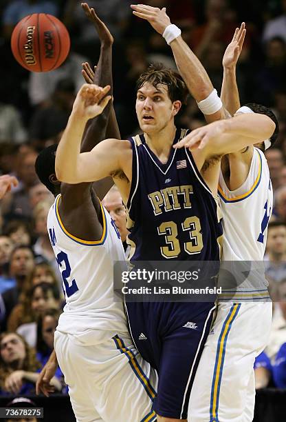 Aaron Gray of the Pittsburgh Panthers passes the ball under pressure from the UCLA Bruins during round three of the NCAA Men's Basketball Tournament...