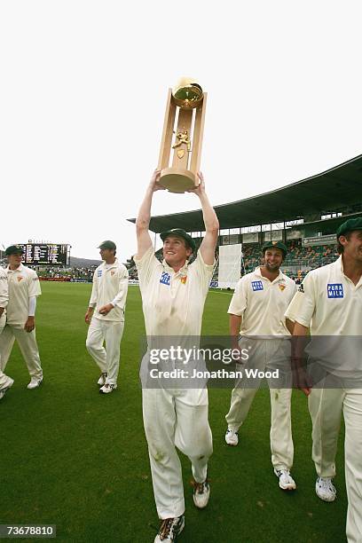 George Bailey of the Tigers holds the Pura Cup trophy after victory in the Pura Cup Final between the Tasmanian Tigers and the New South Wales Blues...