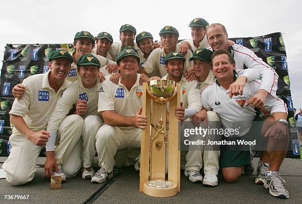 The Tasmanian Tigers pose for photographs with the Pura Cup Trophy after taking victory on day five of the Pura Cup Final between the Tasmanian...