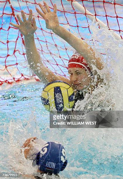Hungary's goalkeeper Patricia Horvath dives to stop a shot from the Cuban attack during the preliminary rounds of the women's water polo at the 12th...