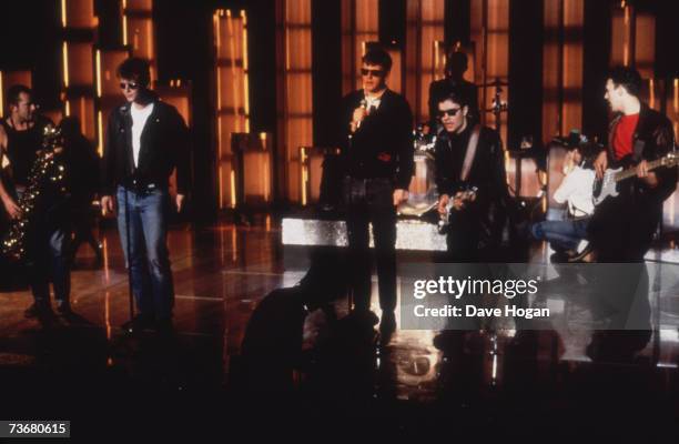 English pop ska band Madness performing on stage, circa 1985. Left to right: Lee Thompson, Mike Barson, Suggs, Chris Foreman and Mark Bedford.