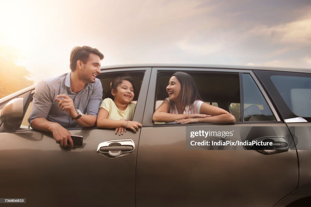 Family looking out car window during their road trip