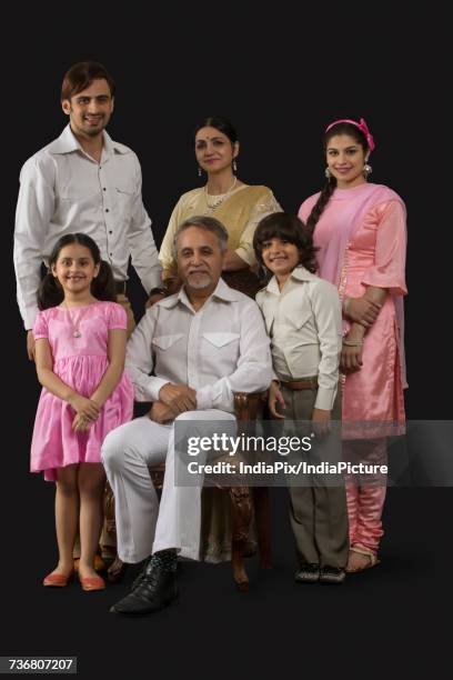 portrait of smiling indian multi-generation family dressed in retro style - glamourous granny stockfoto's en -beelden