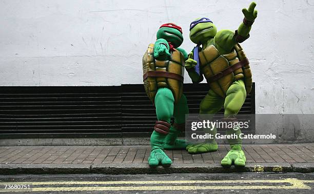 Teenage Mutant Ninja Turtles characters Raphael and Donatello pose outside Hamleys toy store on March 23, 2007 in London, England. The turtles were...