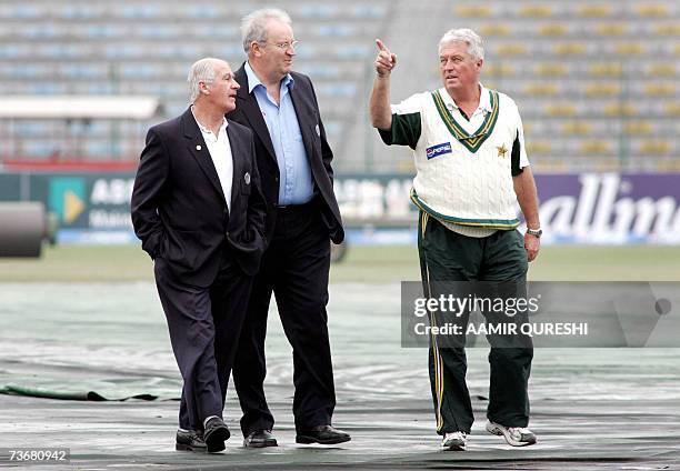 File picture dated 17 January 2006 shows Pakistani cricket team coach Bob Woolmer gesturing as he speaks with match field umpires Darrell Hair and...