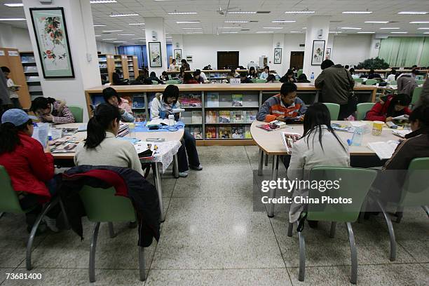 Students read books in the library of the Northeast Normal University on March 22, 2007 in Changchun of Jilin Province, China. China will institute...