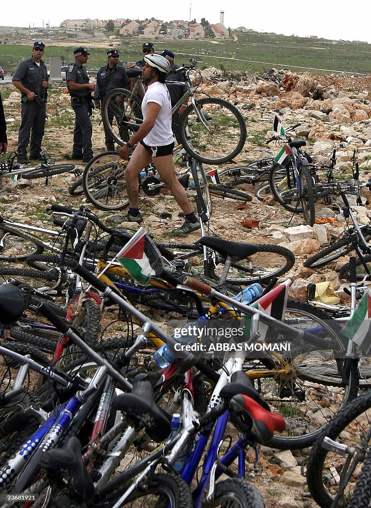 A cyclist walks past bicycles after Isra...