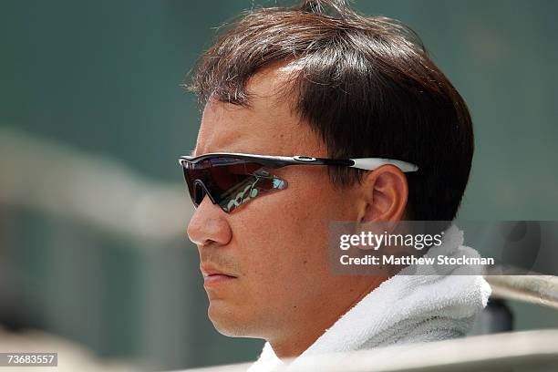 Former tennis star Michael Chang looks on as he watches Ai Sugiyama of Japan, who Chang currently coaches, play Anastasiya Yakimova of Belarus during...