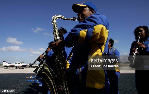 Miami Northwestern Senior high school marching band members play music while people gather to watch Barrington Irving Jr.'s aircraft take flight as...