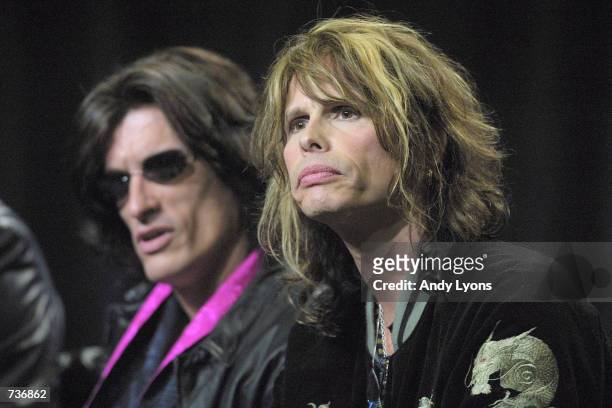 Lead singer Steve Tyler, right, and guitarist Joe Perry from the rock band Aerosmith listen to a question from the media during a press conference...