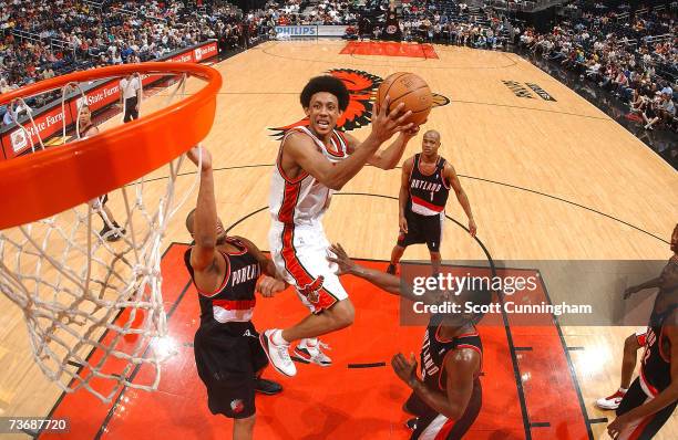 Josh Childress of the Atlanta Hawks splits two defenders and puts up a shot against the Portland Trail Blazers at Philips Arena on March 23, 2007 in...