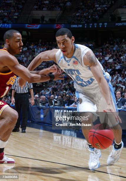 Danny Green of the University of North Carolina Tar Heels drives against Dwight Lewis of the University of Southern California Trojans during the...