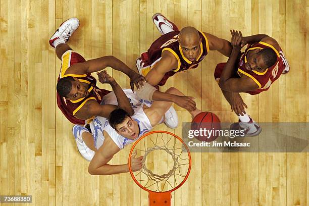 Tyler Hansbrough of the University of North Carolina Tar Heels boxes out against Nick Young and Taj Gibson of the University of Southern California...