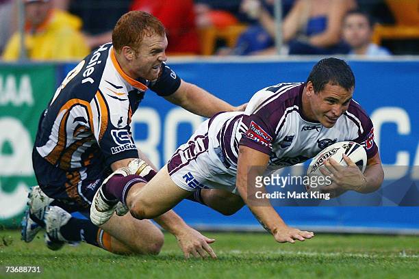 Anthony Watmough of the Sea Eagles dives in to score a try during the round two NRL match between the Wests Tigers and the Manly Warringah Sea Eagles...