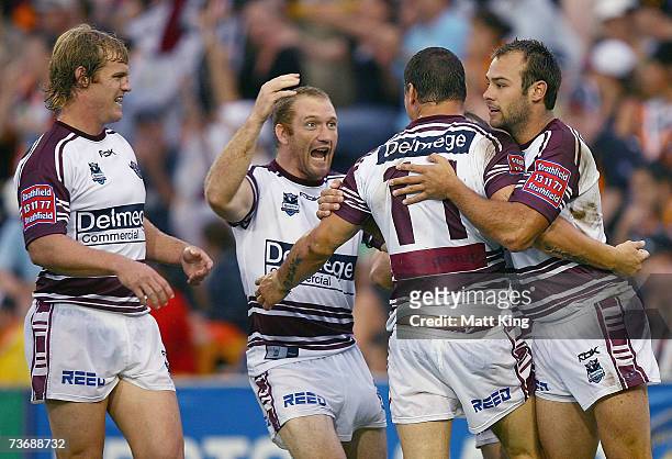 Anthony Watmough of the Sea Eagles is swamped by team mates after scoring a try during the round two NRL match between the Wests Tigers and the Manly...