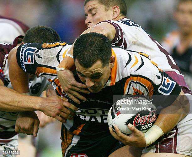 Ben Galea of the Tigers takes on the Sea Eagles defence during the round two NRL match between the Wests Tigers and the Manly Warringah Sea Eagles at...