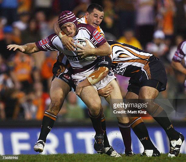 Steve Bell of the Sea Eagles is tackled by the Tigers defence during the round two NRL match between the Wests Tigers and the Manly Warringah Sea...